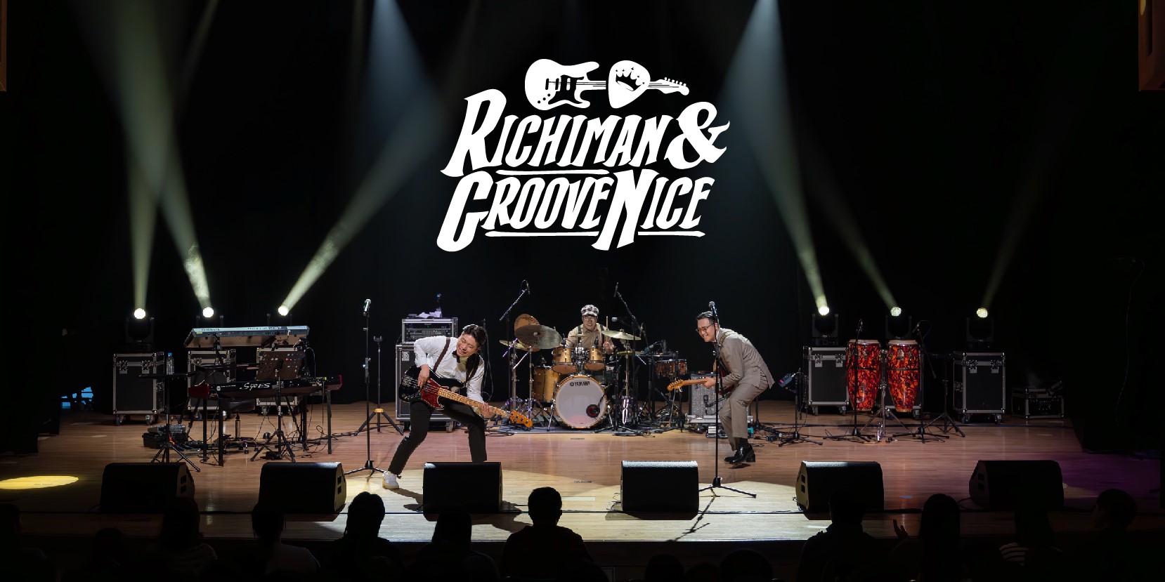 Richiman and Groove Nice logo at the top, Northeastern America Tour at the bottom over a picture of three men playing instruments on stage, one with a guitar, singing, one with a bass guitar, and behind them, one playing the drums. There is stage lighting.